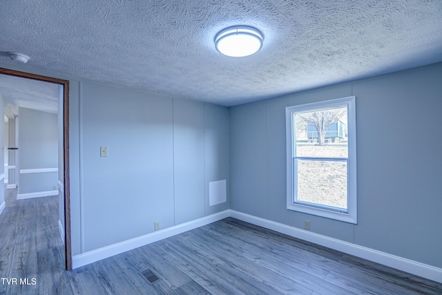 252 Scott Ln, Blountville, TN 37617 - empty room featuring visible vents, a textured ceiling, baseboards, and wood finished floors