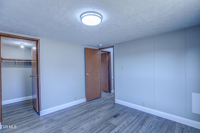 252 Scott Ln, Blountville, TN 37617 - unfurnished bedroom with baseboards, a closet, wood finished floors, and a textured ceiling
