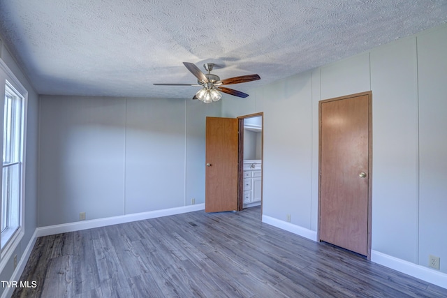 252 Scott Ln, Blountville, TN 37617 - empty room with a textured ceiling, wood finished floors, a decorative wall, and a ceiling fan