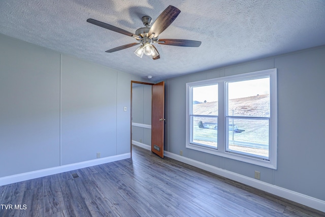 252 Scott Ln, Blountville, TN 37617 - spare room featuring a textured ceiling, baseboards, ceiling fan, and wood finished floors