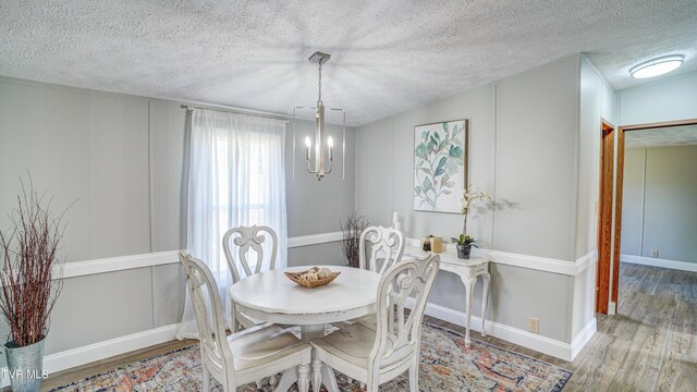 252 Scott Ln, Blountville, TN 37617 - dining area featuring a textured ceiling, wood finished floors, and an inviting chandelier