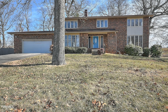 view of property with a garage and a front lawn