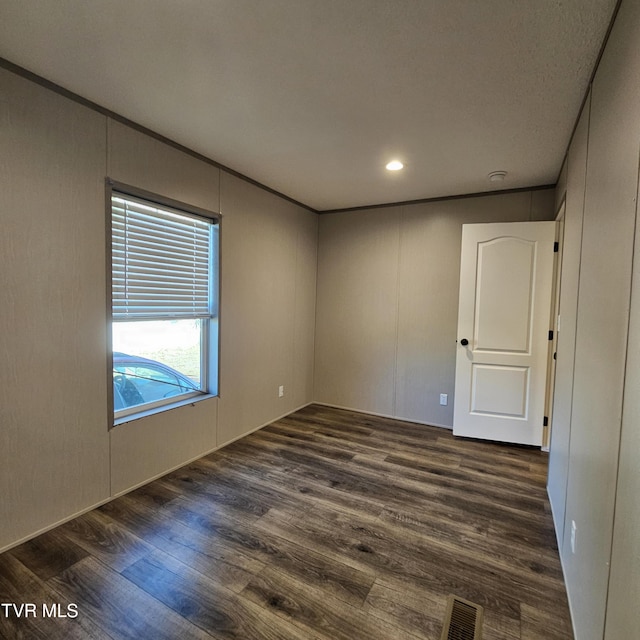 spare room with dark hardwood / wood-style floors