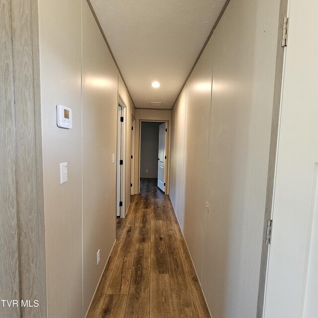 hallway with dark wood-type flooring