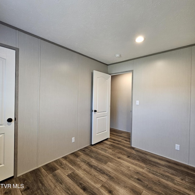 interior space with dark hardwood / wood-style flooring and a textured ceiling