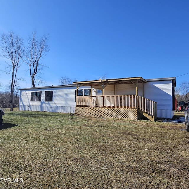 view of front of property with a wooden deck and a front lawn