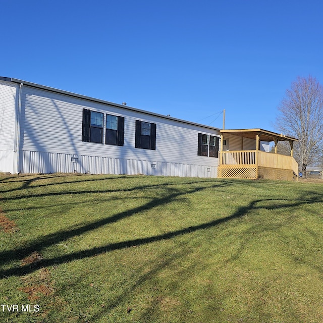 rear view of property with a yard