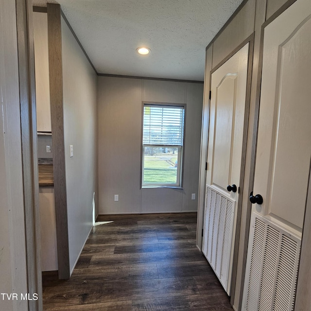 interior space featuring dark hardwood / wood-style floors and a textured ceiling