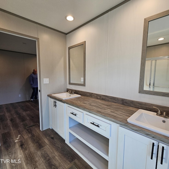 bathroom featuring vanity, hardwood / wood-style floors, and a shower with shower door