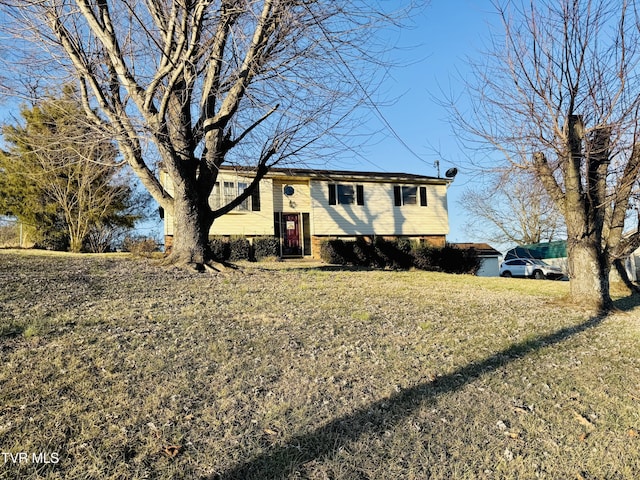 raised ranch with a front yard