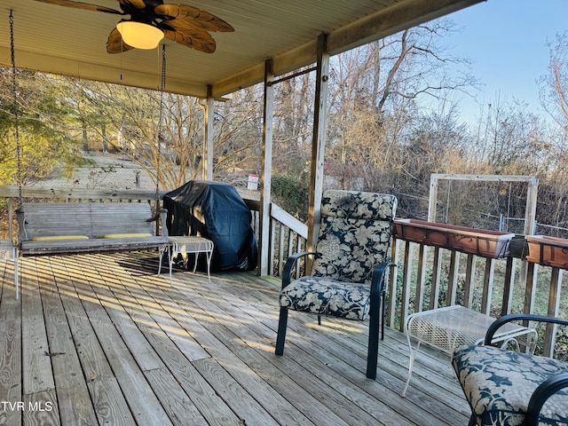 wooden deck featuring area for grilling and ceiling fan