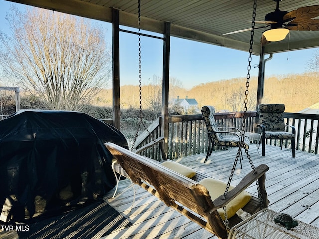 wooden deck featuring grilling area and ceiling fan