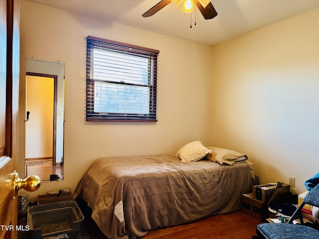 bedroom with ceiling fan and wood-type flooring