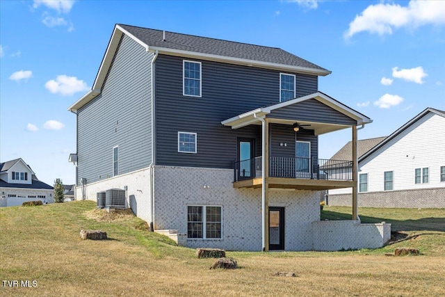 back of property featuring cooling unit, a yard, and ceiling fan