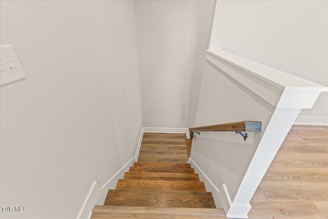 stairway with hardwood / wood-style flooring