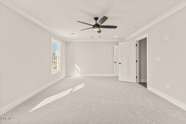 carpeted spare room featuring crown molding and ceiling fan