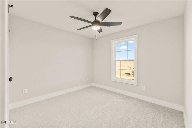 spare room featuring ceiling fan and carpet