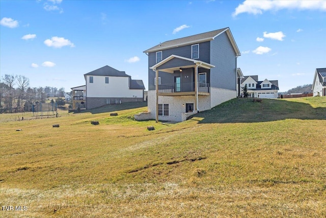 rear view of property featuring a lawn