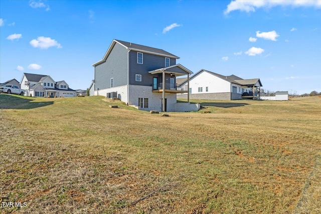 back of house featuring cooling unit and a yard