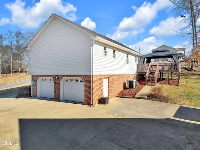 view of property exterior with a gazebo, a garage, and central AC unit