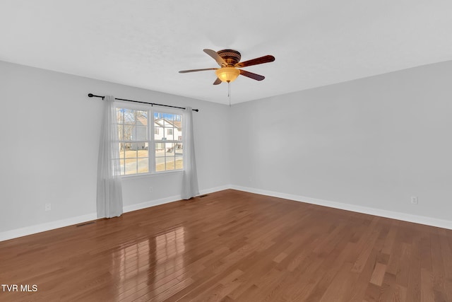 unfurnished room with hardwood / wood-style flooring and ceiling fan