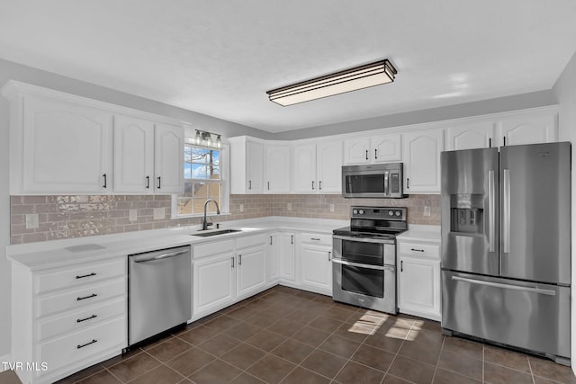 kitchen featuring tasteful backsplash, stainless steel appliances, sink, and white cabinets