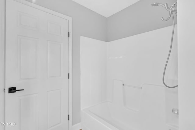 bathroom with bathing tub / shower combination