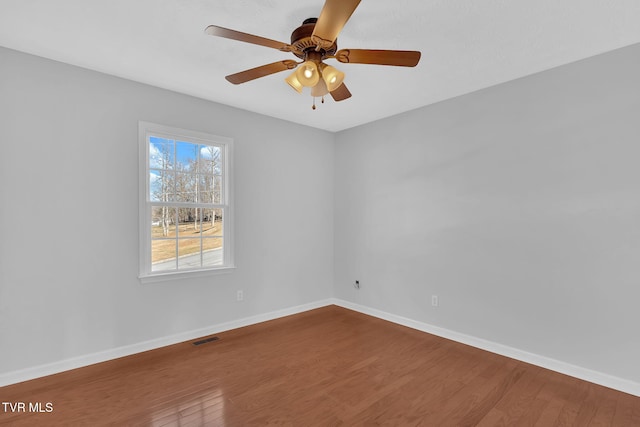 empty room featuring hardwood / wood-style floors and ceiling fan