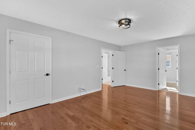 unfurnished bedroom with wood-type flooring