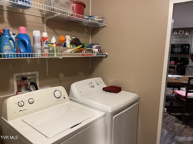 washroom featuring separate washer and dryer and wood-type flooring