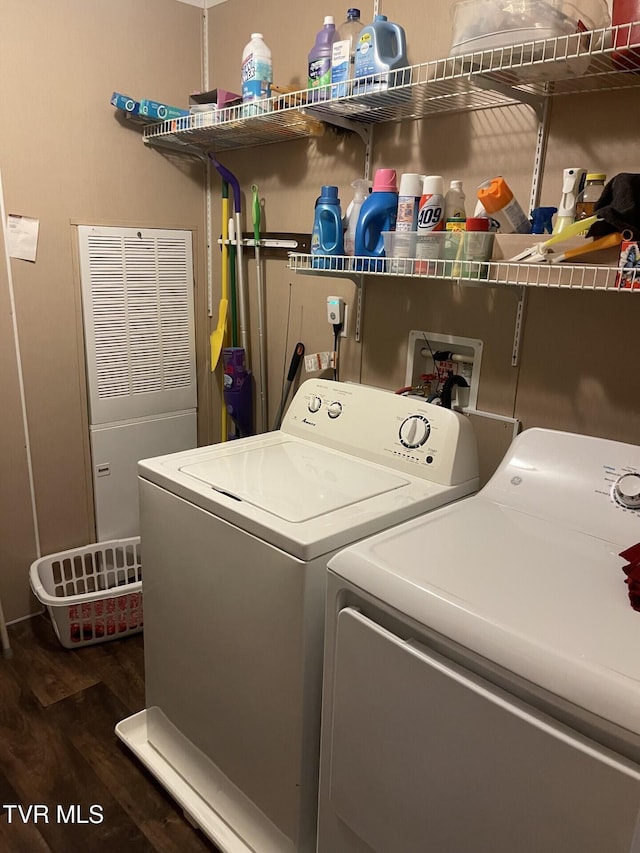 laundry room featuring dark hardwood / wood-style floors and washer and dryer