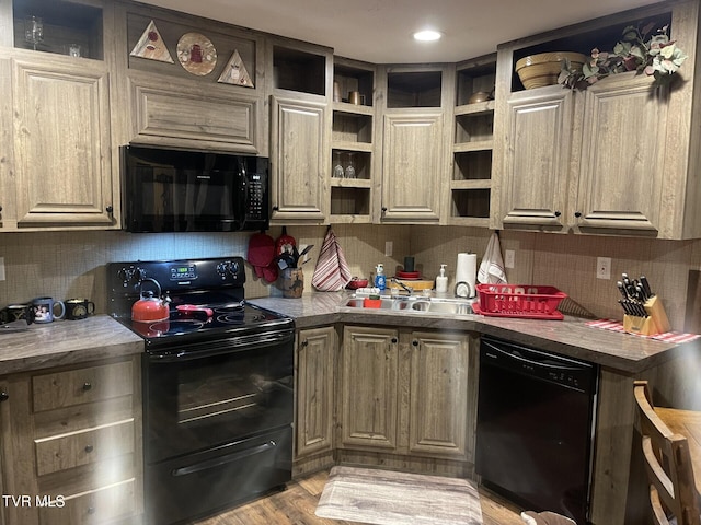 kitchen with tasteful backsplash, sink, black appliances, and light wood-type flooring