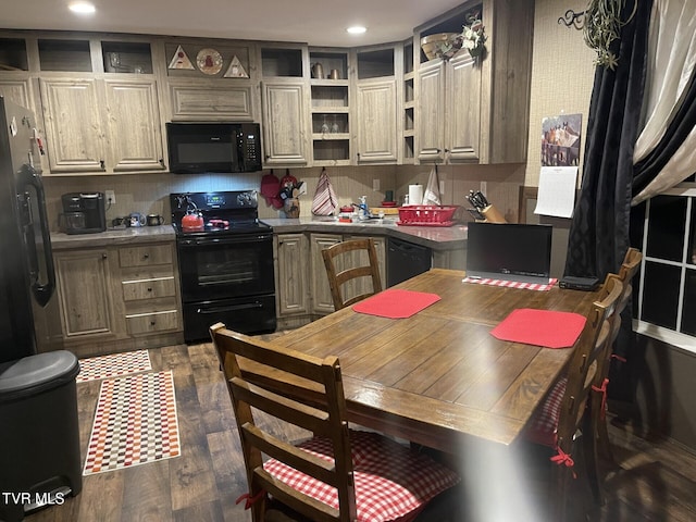 kitchen with tasteful backsplash, sink, black appliances, and dark hardwood / wood-style floors