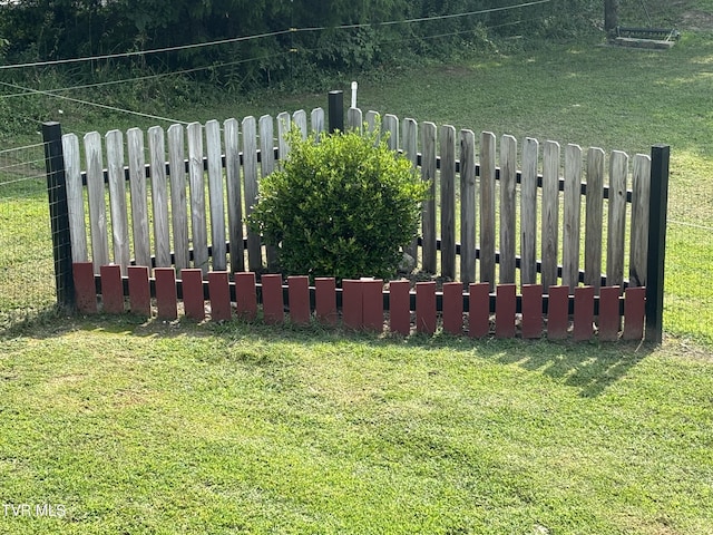 view of gate featuring a yard