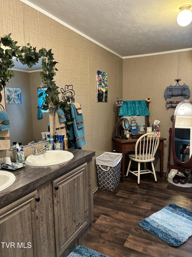 bathroom featuring ornamental molding, vanity, hardwood / wood-style floors, and a textured ceiling