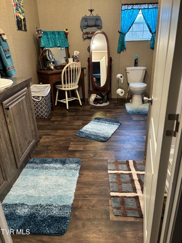 bathroom featuring vanity, hardwood / wood-style floors, and toilet