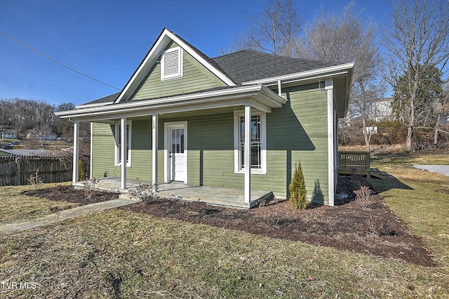 view of front of property with a porch and a front lawn