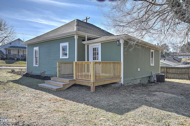 back of house with central AC unit