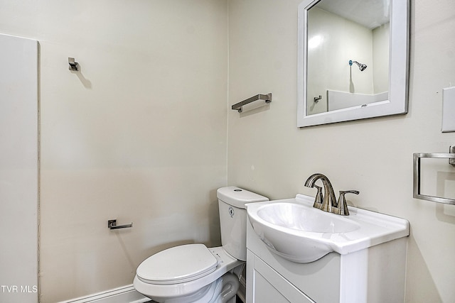 bathroom with vanity, toilet, and baseboard heating