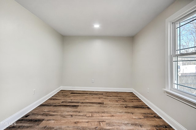 unfurnished room with wood-type flooring