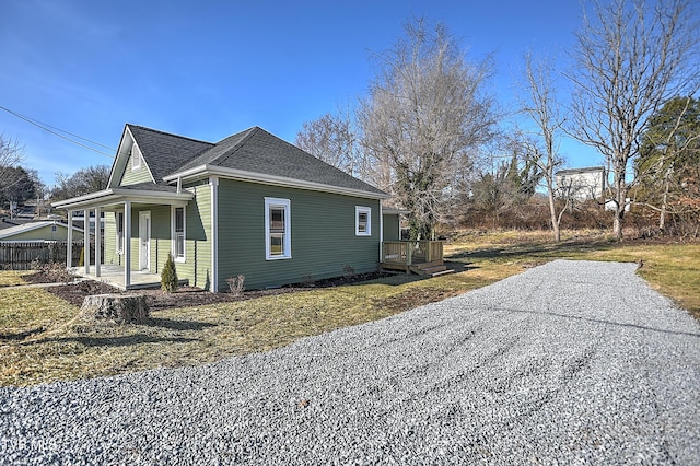 view of side of home with a wooden deck and a porch