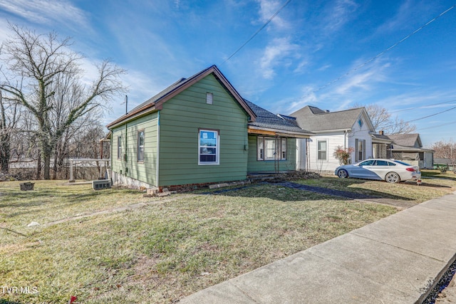 view of front of home featuring a front yard and central air condition unit