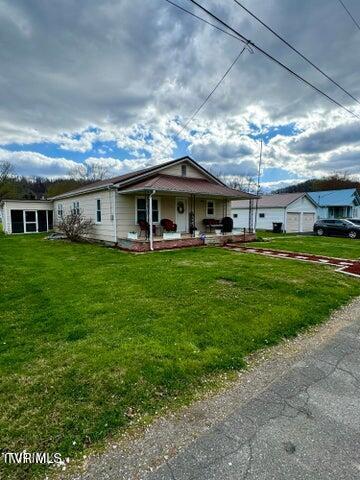 ranch-style house with a porch and a front yard