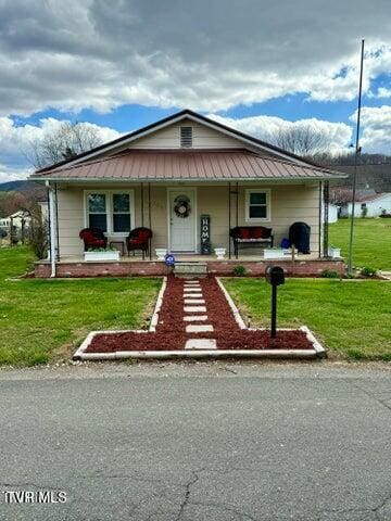 view of front of house with a porch and a front lawn