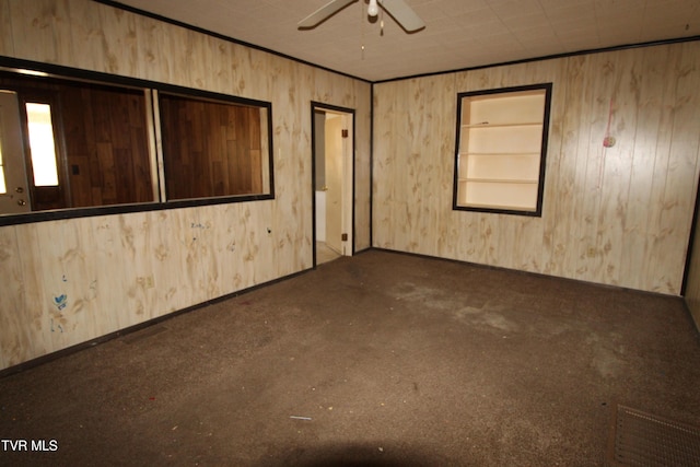 unfurnished room featuring ceiling fan and ornamental molding