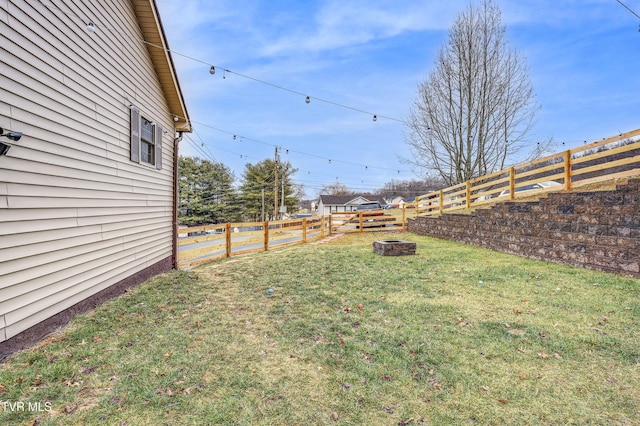 view of yard with a fire pit