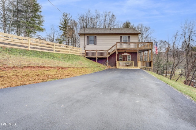 view of property featuring a front yard and a deck