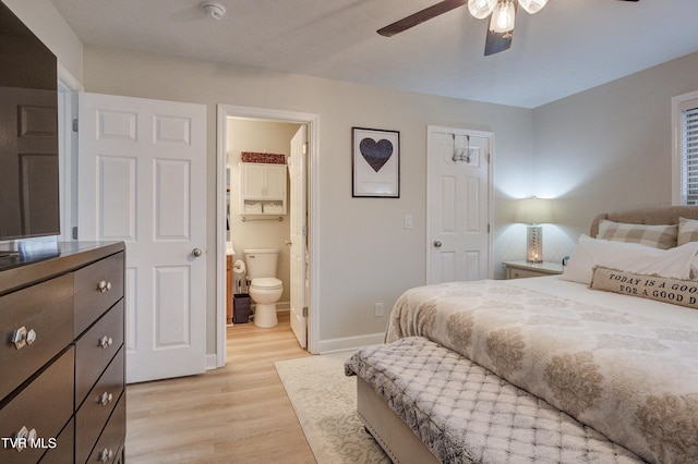 bedroom with ensuite bath, ceiling fan, and light wood-type flooring