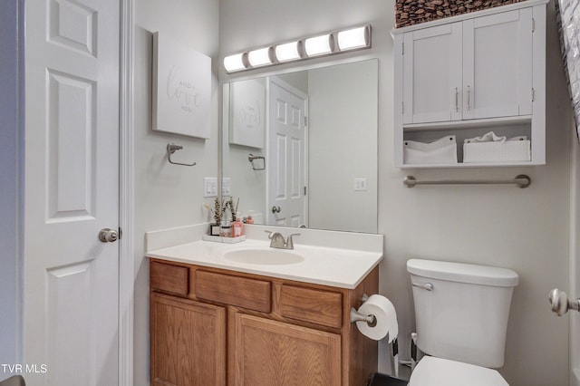 bathroom featuring vanity and toilet