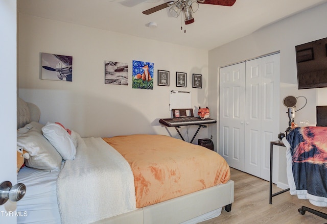 bedroom with ceiling fan, a closet, and light hardwood / wood-style flooring